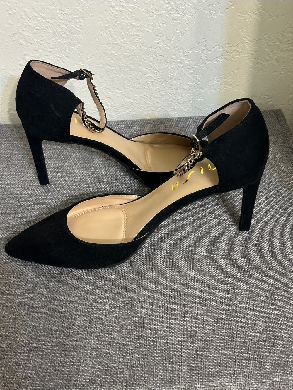 Unisa Black Suede Pointed Toe Ankle-Strap Heels with Chain Accent